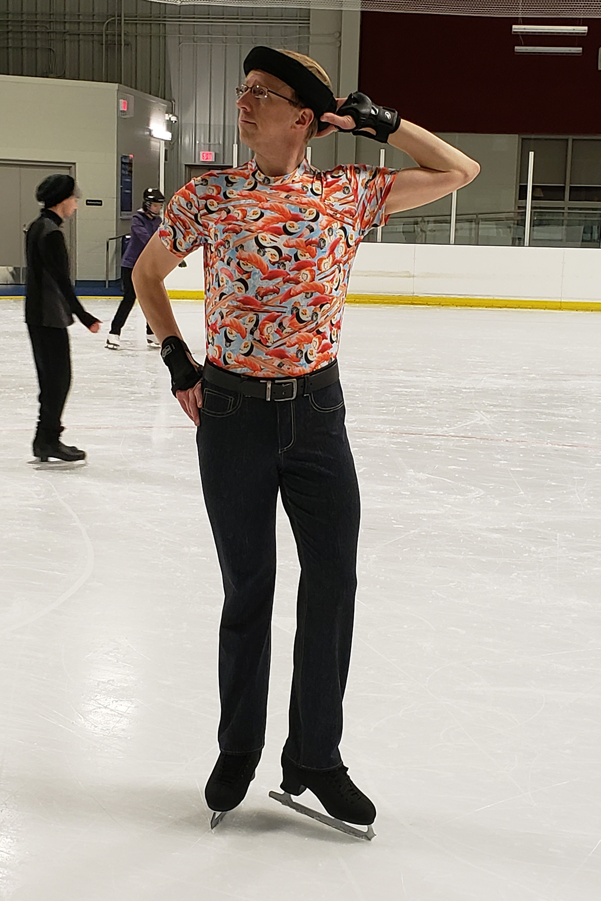 A male ice skater posing on the ice.