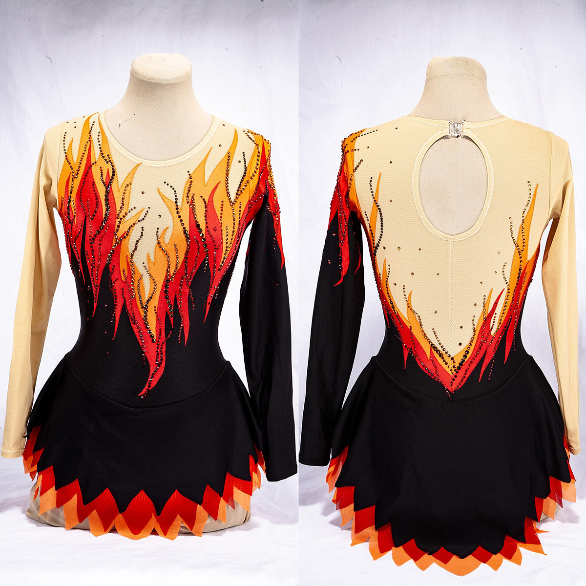 Front and back views of a flames design figure skating dress on a dress form.