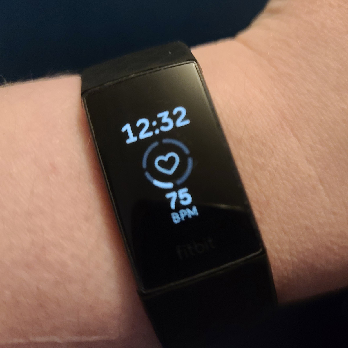 A fitbit on a woman's wrist.