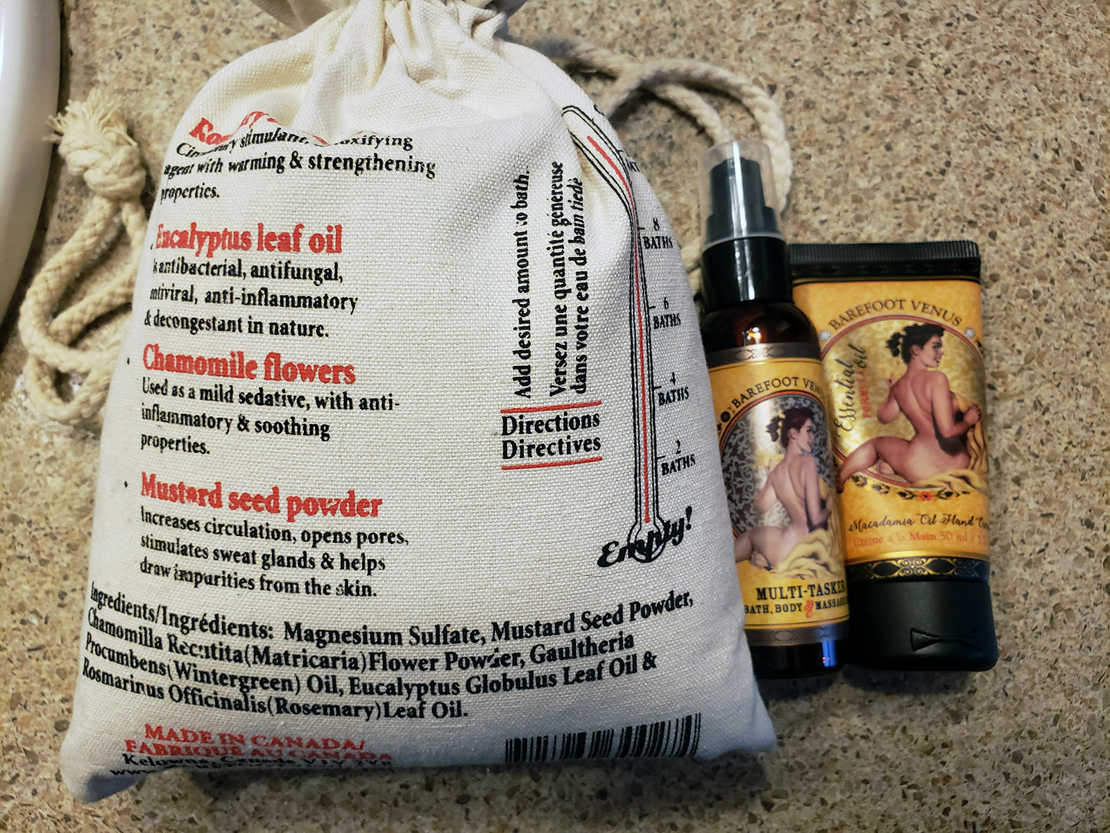 A bag of Barefoot Venus Mustard Bath, along with a lotion and an oil spray.
