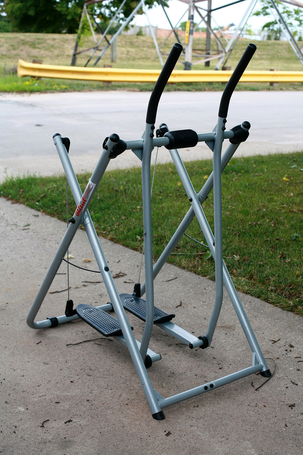 A Gazelle exercise machine in a driveway.