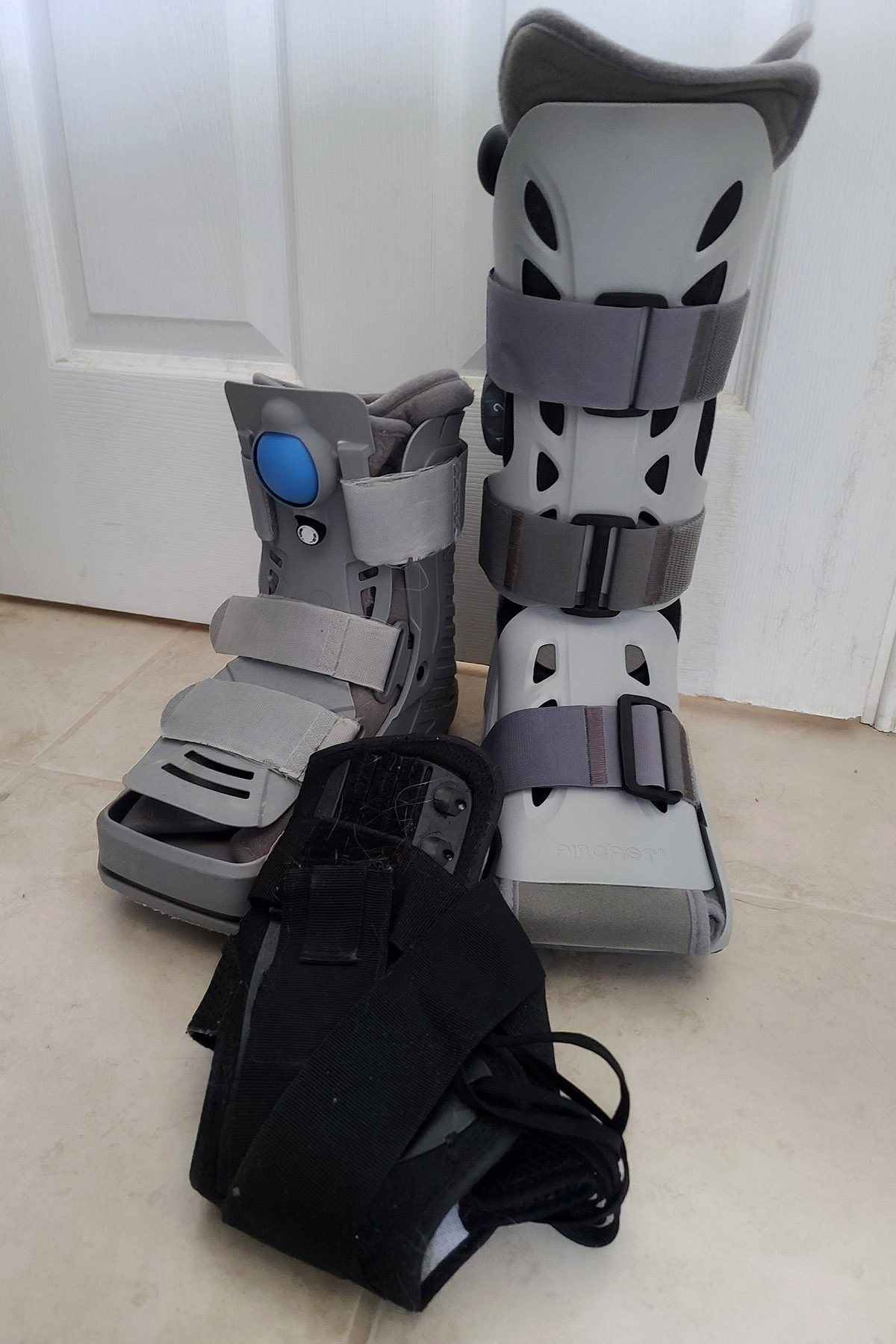 2 orthotic boots and an ankle brace.